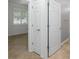Hallway leading to bedroom with tile floors and window with shutter-style blinds for filtered natural light at 7709 Sw 86Th Ct, Ocala, FL 34481