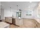 Modern kitchen with granite island, stainless appliances, and an open layout to the dining area at 7709 Sw 86Th Ct, Ocala, FL 34481