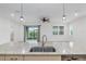 Granite countertop with a double sink and stainless steel appliances in a well-lit kitchen at 7709 Sw 86Th Ct, Ocala, FL 34481