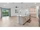 Open kitchen with a large center island, sleek appliances, tile flooring, and plenty of natural light at 7709 Sw 86Th Ct, Ocala, FL 34481