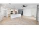 An open-concept kitchen and living room boasts tile floors, granite countertops, and stainless appliances at 7709 Sw 86Th Ct, Ocala, FL 34481