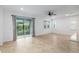 Open-concept living space with tile floors, sliding glass doors to the lanai, and natural light at 7709 Sw 86Th Ct, Ocala, FL 34481