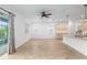 Bright open living space with a kitchen island, tile flooring, and access to outdoor space at 7709 Sw 86Th Ct, Ocala, FL 34481