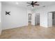 Spacious main bedroom with tile floors, ceiling fan, and adjoining bathroom at 7709 Sw 86Th Ct, Ocala, FL 34481