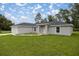 Gray house with a covered entryway and landscaped lawn at 14573 Sw 25Th Ter, Ocala, FL 34473