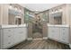 Modern bathroom featuring a glass enclosed shower and dual sink vanity with quartz countertop at 706 Stanley Ave, Wildwood, FL 34785