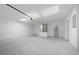 Spacious two car garage featuring an automatic door opener and mechanical room at 706 Stanley Ave, Wildwood, FL 34785