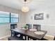 Bright dining area with a dark wood table and woven light fixture at 7131 Sw 19Th Avenue Road Rd, Ocala, FL 34476