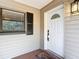 White front door entry with sidelights and a decorative glass at 7131 Sw 19Th Avenue Road Rd, Ocala, FL 34476