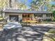 Front view of a ranch house with a metal roof, garage, and deck at 7131 Sw 19Th Avenue Road Rd, Ocala, FL 34476