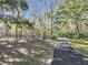 Paved pathway meandering through a lush, wooded landscape at 7131 Sw 19Th Avenue Road Rd, Ocala, FL 34476