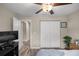 Neutral bedroom featuring a ceiling fan, a spacious closet, and warm wood-look floors at 7336 Sw 131St Ln, Ocala, FL 34473