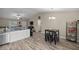 Well-lit kitchen featuring granite countertops, a stainless steel sink, and a seamless connection to living spaces at 7336 Sw 131St Ln, Ocala, FL 34473