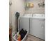 Functional laundry room with a stacked washer and dryer, plus convenient shelving and storage solutions at 7336 Sw 131St Ln, Ocala, FL 34473