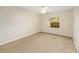 Inviting bedroom with neutral carpeting, ceiling fan, and a window offering natural light at 4937 Nw 30Th Pl, Ocala, FL 34482