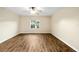 Bedroom featuring laminate flooring, a ceiling fan, and a large window providing natural light at 4937 Nw 30Th Pl, Ocala, FL 34482