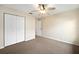 Neutral bedroom featuring carpet flooring, ceiling fan, and double door closet for ample storage at 4937 Nw 30Th Pl, Ocala, FL 34482