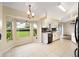Sunlit breakfast nook with tiled floors and a view of the backyard, adjacent to the kitchen at 4937 Nw 30Th Pl, Ocala, FL 34482