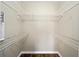 Walk-in closet featuring wood laminate flooring and white wire shelving for organization at 4937 Nw 30Th Pl, Ocala, FL 34482