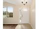 Inviting foyer featuring tile flooring, a glass-paneled door, and a large window for natural light at 4937 Nw 30Th Pl, Ocala, FL 34482