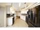 Modern kitchen featuring sleek black appliances, white cabinetry, and stylish backsplash at 4937 Nw 30Th Pl, Ocala, FL 34482
