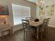 Cozy dining room with a farmhouse-style table set for six, illuminated by a modern chandelier at 9029 Se 47Th Court Rd, Ocala, FL 34480