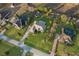 Aerial view of a well-manicured property with mature trees and a long driveway at 6925 Se 96Th Place Rd, Belleview, FL 34420