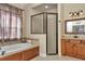 Bathroom featuring a soaking tub under the window and a glass-enclosed shower at 6925 Se 96Th Place Rd, Belleview, FL 34420