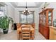 Formal dining room featuring a wood table, cabinet, and natural lighting at 6925 Se 96Th Place Rd, Belleview, FL 34420