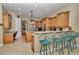 Kitchen with breakfast bar seating, wooden cabinets, and granite countertops at 6925 Se 96Th Place Rd, Belleview, FL 34420