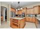 Traditional kitchen featuring wooden cabinets, stainless steel appliances, and granite countertops at 6925 Se 96Th Place Rd, Belleview, FL 34420