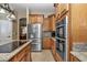 Shows the kitchen's stainless steel refrigerator, double ovens, and granite countertops at 6925 Se 96Th Place Rd, Belleview, FL 34420
