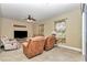 Cozy living room with tile flooring, comfortable seating, and natural light at 6925 Se 96Th Place Rd, Belleview, FL 34420
