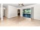 Spacious living room featuring neutral tones and large sliding glass doors leading to outdoor living space at 6925 Se 96Th Place Rd, Belleview, FL 34420