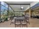 Enjoy the screened patio with a dining table and comfortable seating area surrounded by nature at 6925 Se 96Th Place Rd, Belleview, FL 34420