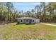 Inviting single-story home featuring a well-maintained lawn and a charming front entryway in a wooded location at 11404 Sw 131St Ter, Dunnellon, FL 34432