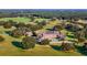 Serene estate with sprawling lawns, mature trees, main residence, pool, and guest houses at 17800 Se 237Th Ct, Umatilla, FL 32784
