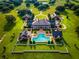 Expansive estate featuring a grand residence, pool with spas, guest houses, and lush green lawns at 17800 Se 237Th Ct, Umatilla, FL 32784