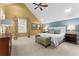 Bedroom featuring high ceilings, carpet, and an assortment of furniture at 17800 Se 237Th Ct, Umatilla, FL 32784
