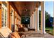 Expansive covered patio featuring brick facade, ceiling fans, and stone flooring with relaxing furniture at 17800 Se 237Th Ct, Umatilla, FL 32784