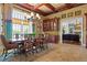 Formal dining room with large windows, a decorative chandelier and custom furniture at 17800 Se 237Th Ct, Umatilla, FL 32784