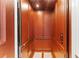 Elevator interior showcasing elegant wood paneling, a handrail, and user-friendly control buttons at 17800 Se 237Th Ct, Umatilla, FL 32784
