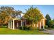 Beautiful brick home with a covered porch, white columns, and mature landscaping at 17800 Se 237Th Ct, Umatilla, FL 32784