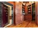 Home office with a reinforced vault door, and built-in wooden shelves at 17800 Se 237Th Ct, Umatilla, FL 32784