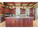 Spacious kitchen with custom cabinets, granite countertops, and a center island with sink at 17800 Se 237Th Ct, Umatilla, FL 32784