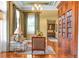 Cozy living room with hardwood floors, custom bookshelf and soft, natural light from the adjacent window at 17800 Se 237Th Ct, Umatilla, FL 32784