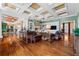 Living room with coffered ceilings, a fireplace and large windows at 17800 Se 237Th Ct, Umatilla, FL 32784