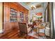 Spacious living room with custom built-in bookshelves, hardwood flooring, and refined furniture at 17800 Se 237Th Ct, Umatilla, FL 32784