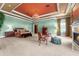 A large main bedroom suite with a fireplace, sitting area, and elegant chandelier at 17800 Se 237Th Ct, Umatilla, FL 32784