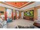 Comfortable media room with plush seating, large screen display, and custom colored walls and trim at 17800 Se 237Th Ct, Umatilla, FL 32784